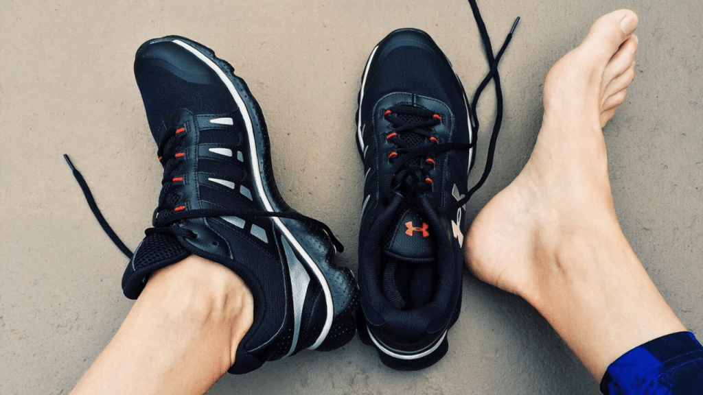 Man with shoes off due to plantar fasciitis pain, needing the help of an Austin physical therapist