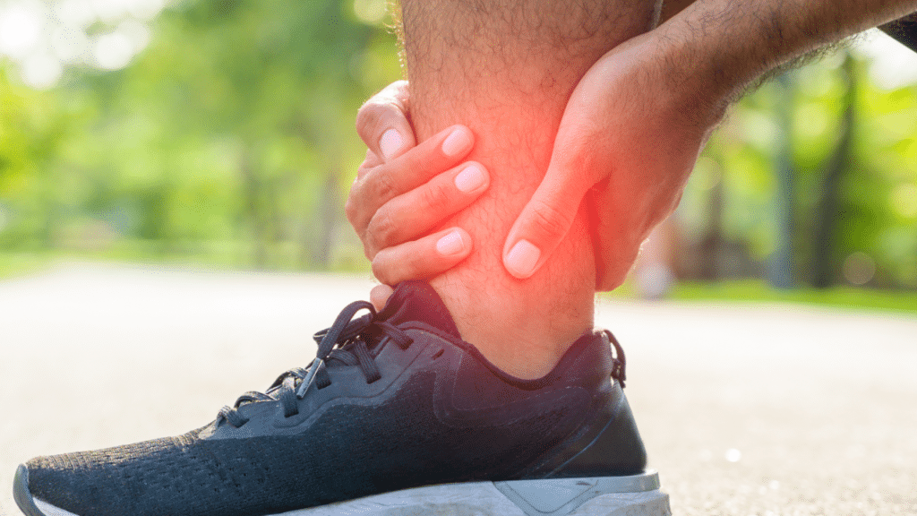 Man holding sprained ankle in pain