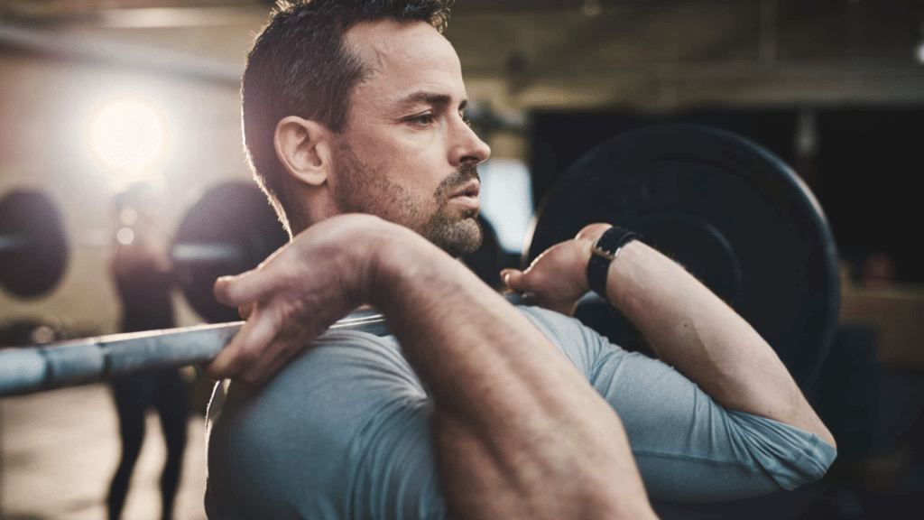 Man lifting weights with tight muscles