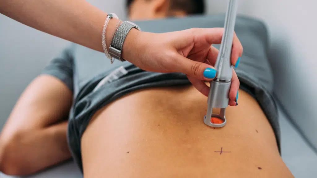 Cold laser treatment being used on a patient's back