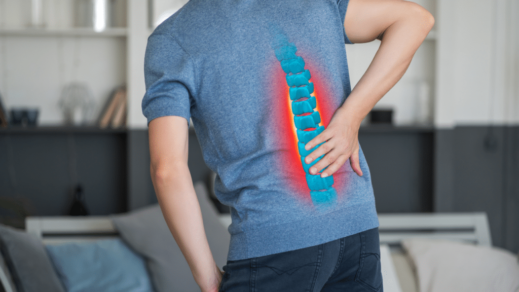 Man grabs back in pain as a diagram of his spine lights up, indicating there may be a herniated disc