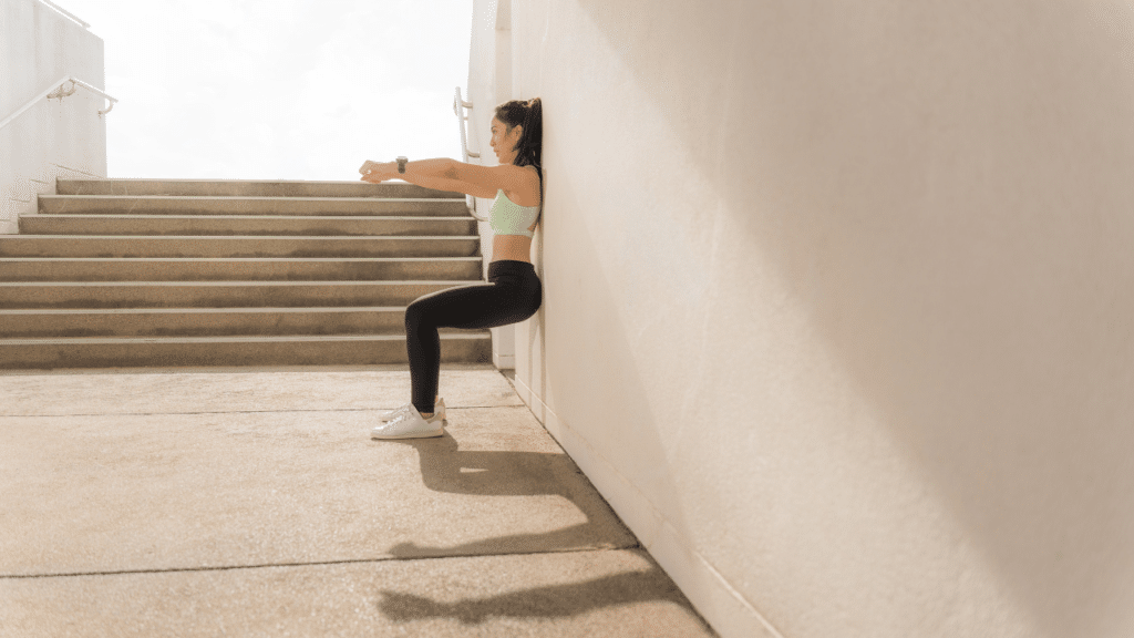 Woman doing wall sits to help with disc herniation