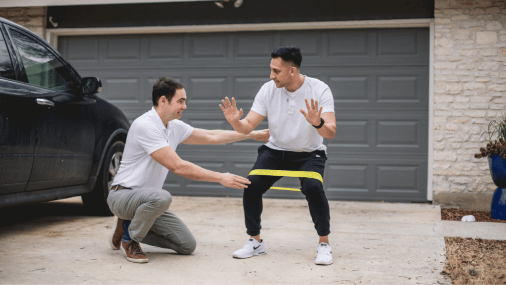 Eric Finger works with a patient in his driveway on a therapeutic exercise while discussing What Is Concierge Physical Therapy?