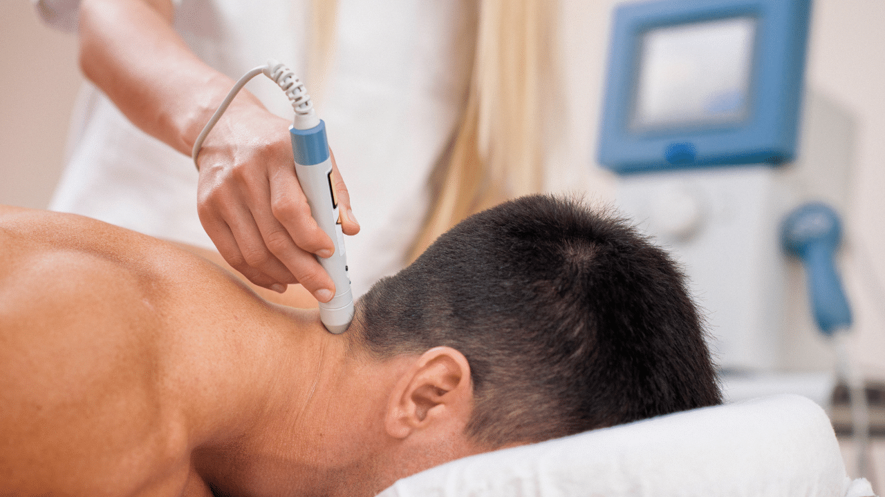 Physical Therapist in Austin Texas is giving a patient Cold Laser Therapy as a Healing Shortcut for their Active Lifestyle Needs