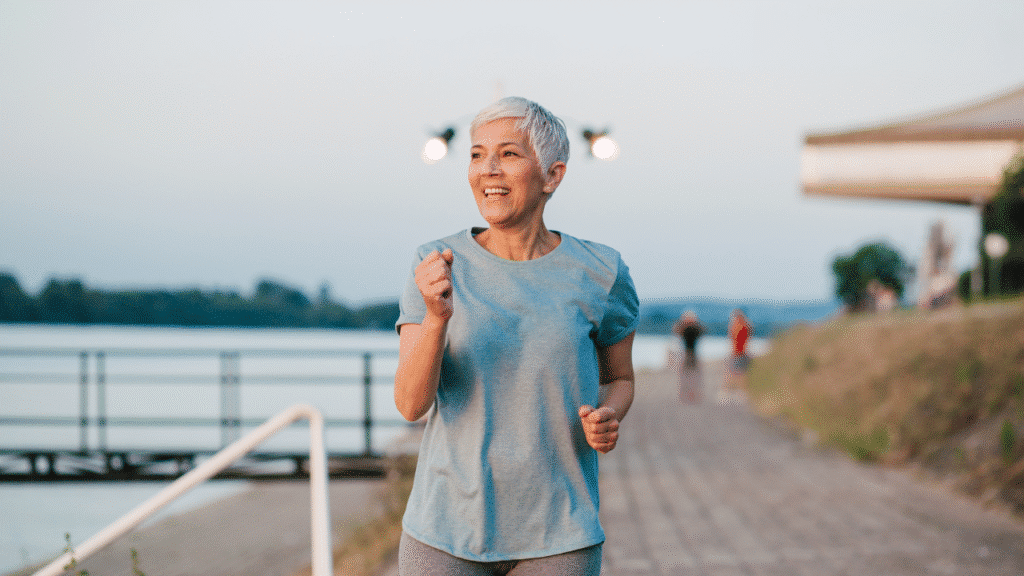 Older woman smiling and jogging as someone who experiences hypermobility