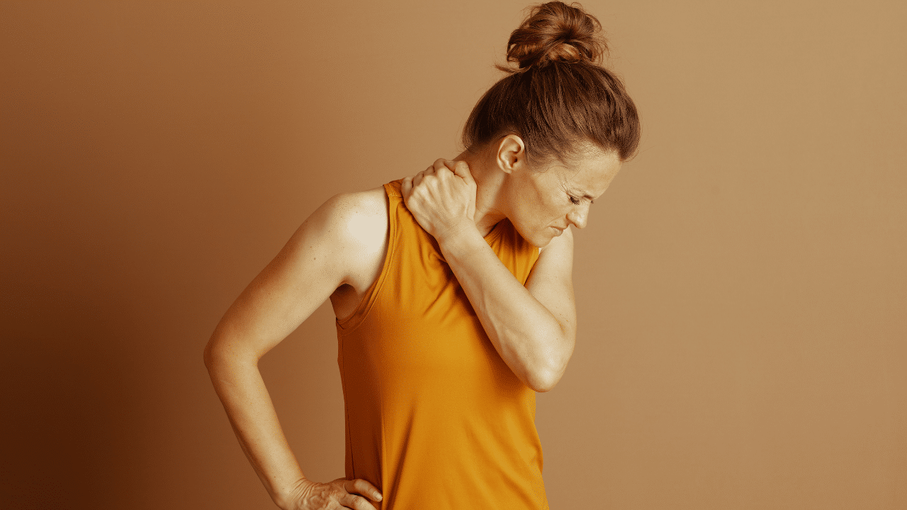 Woman grips neck due to Neck Pain From Desk Use And Technology