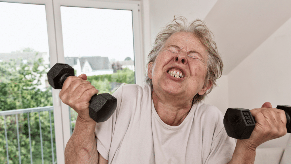 Woman struggling to lift weights and learning Why Strength Training in Older Women Matters in Austin
