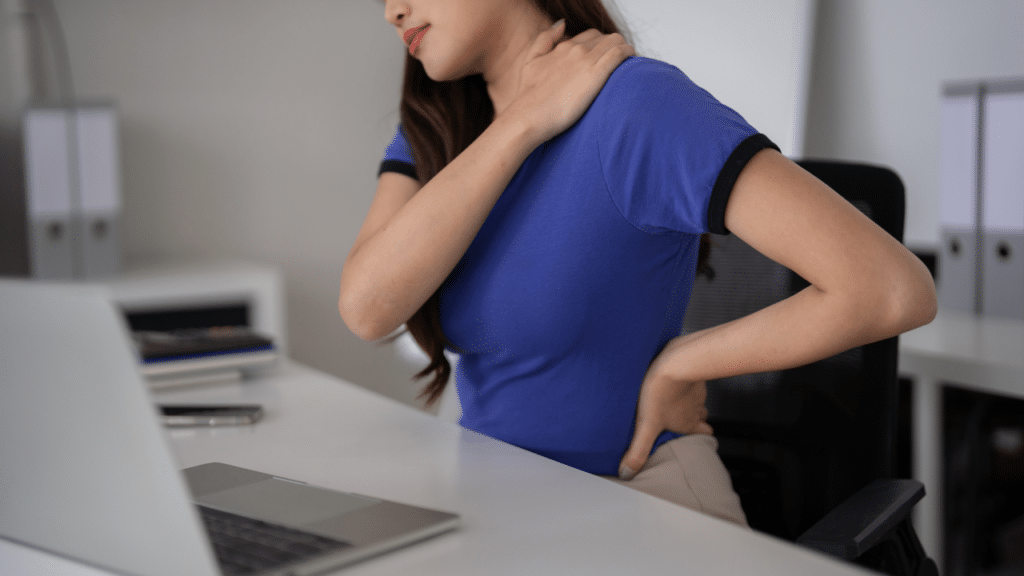 Woman holds neck in pain demonstrating how Your Shoulder Blade Pain Could Be A Rib Or Thoracic Spine Problem