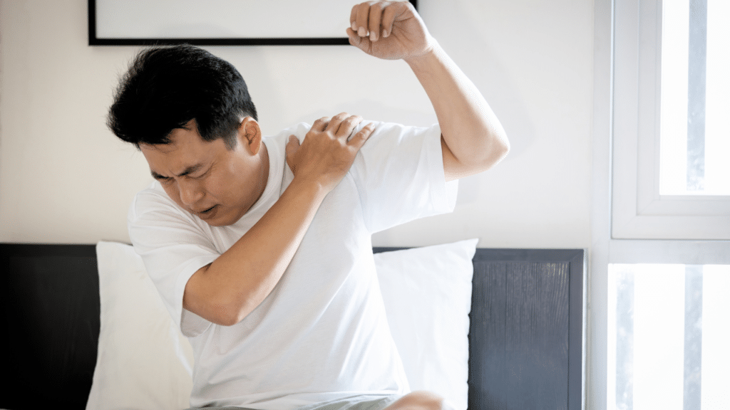 Man tries to lift arm in pain, The Three Stages of Frozen Shoulder