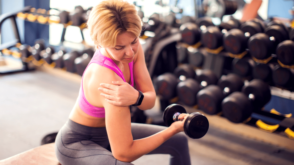 Woman works out and holds shoulder wondering Why Shoulder Pain Spikes in Women in Their 40s to 60s
