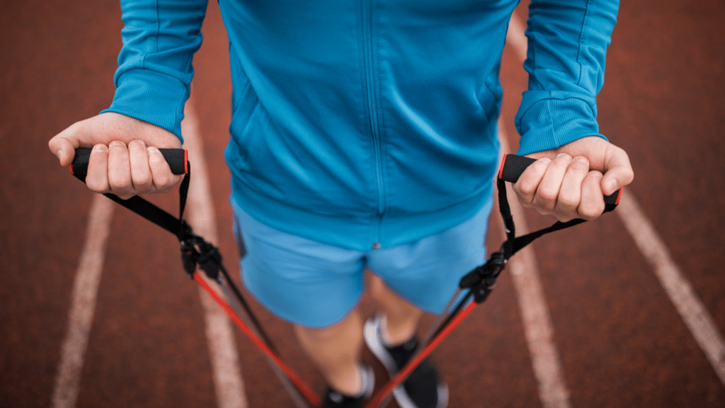 Man uses resistance bands on foot while learning Loading Versus Stretching for Hip Flexors