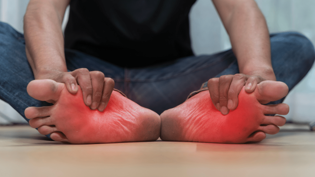 Person holding feet in pain wondering Is My Foot Pain Actually a Back Problem Showing Up in My Foot?