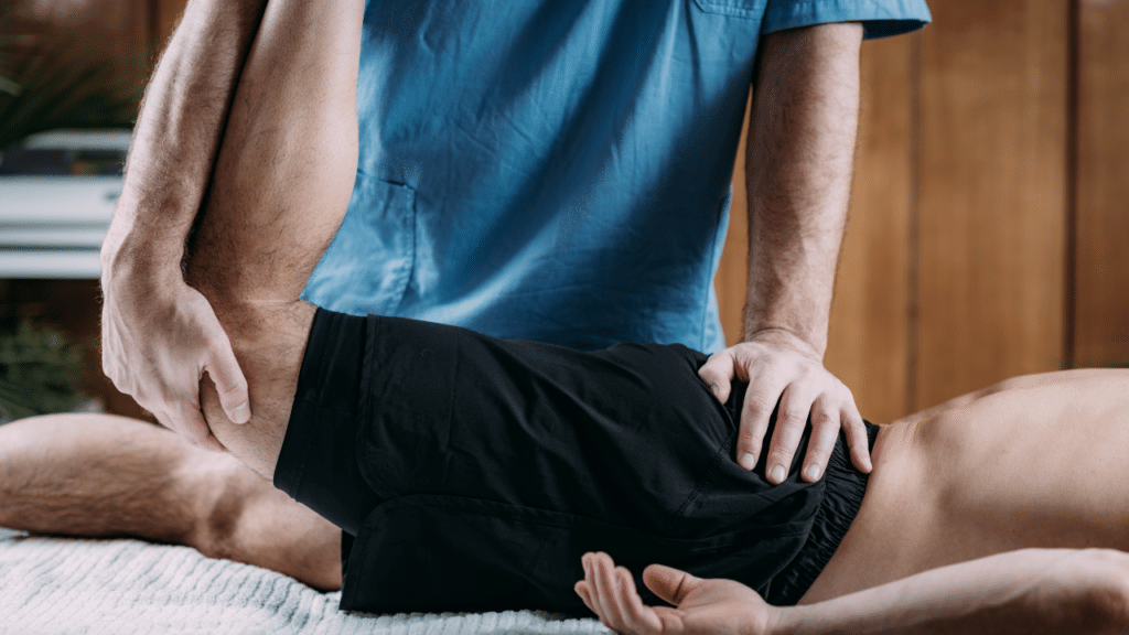 Physical therapist work's on patient's leg as part of in-home physical therapy in Allandale, TX