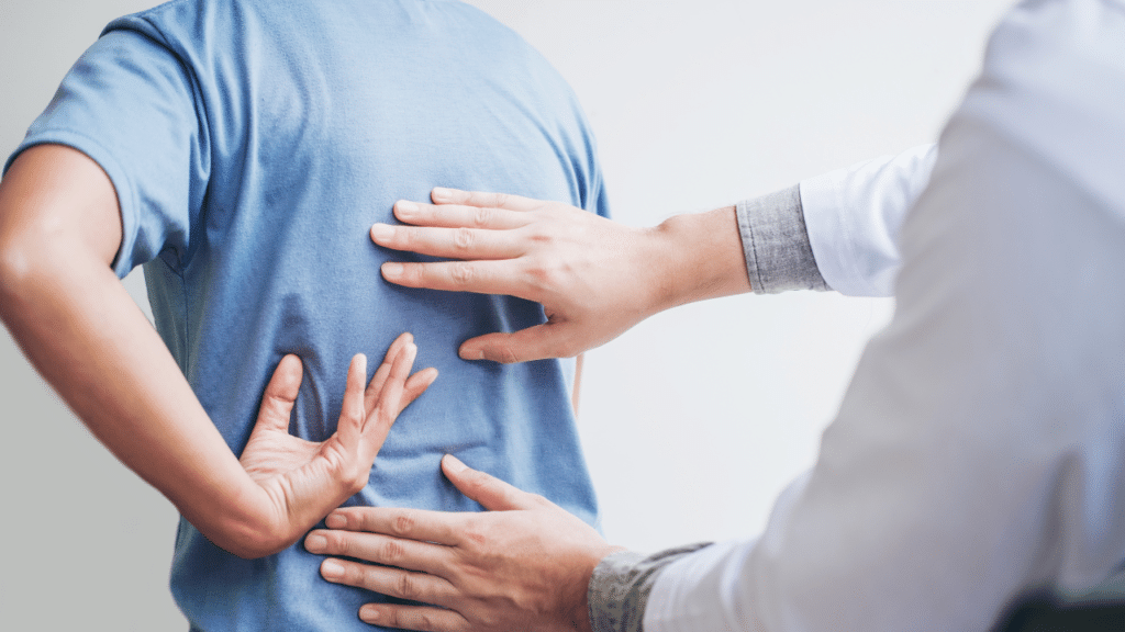 PT in Austin, TX examines a patient's back