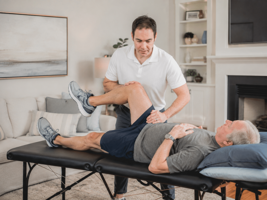 PT moves patient's leg to help with back pain in Austin, TX