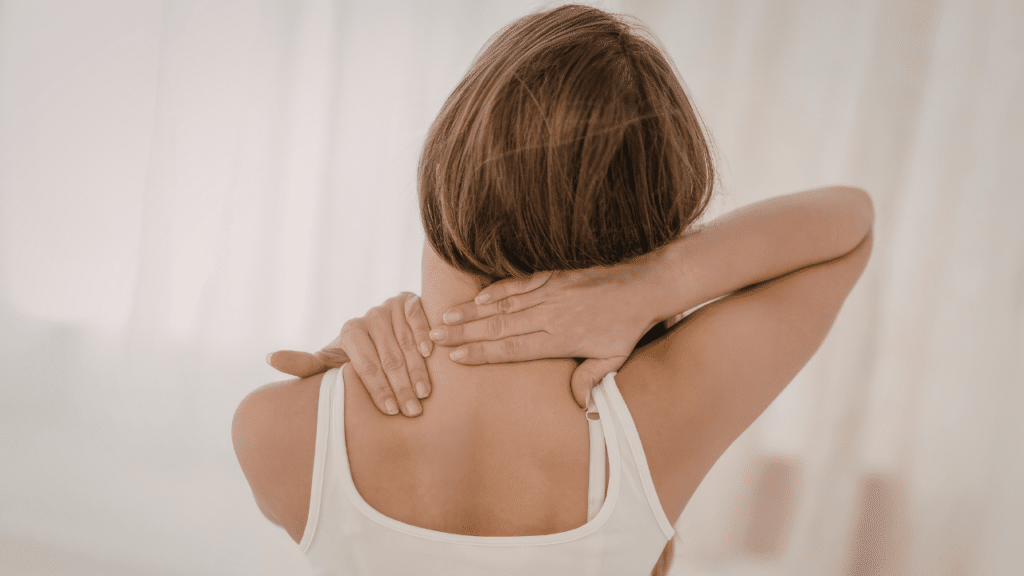 woman holds neck in pain before being told about the 10 Things Worth Knowing About Adhesions And Shockwave Therapy