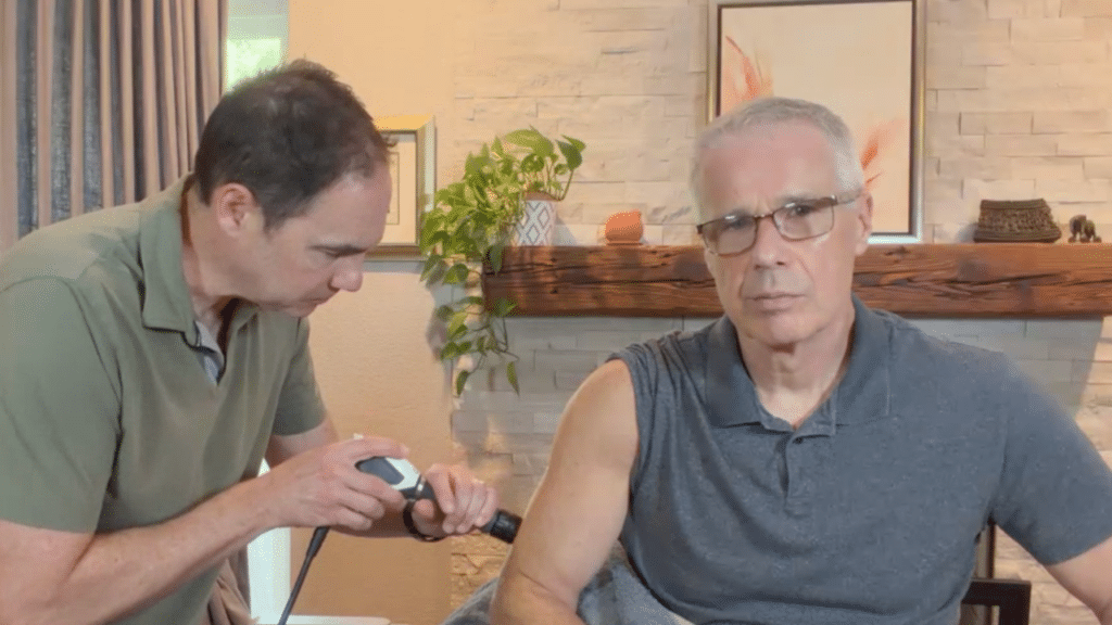 austin tx physical therapist uses austin tx shockwave therapy on patient during in home physical therapy session