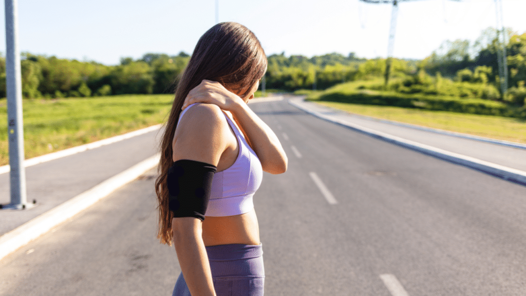 woman holds shoulder in pain, wondering about shockwave therapy austin tx