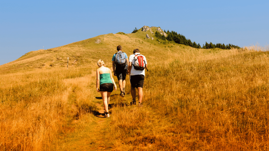 group hikes a big hill before calling a northwest hills tx physical therapist